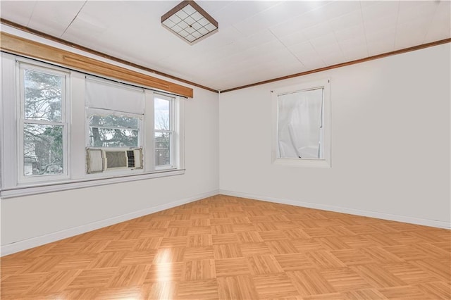 empty room with baseboards, plenty of natural light, and ornamental molding