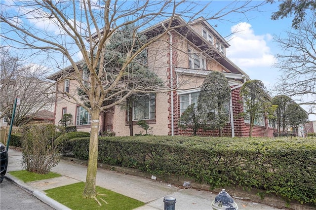 view of front of home featuring brick siding