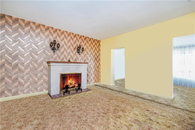 unfurnished living room with a fireplace with flush hearth and carpet