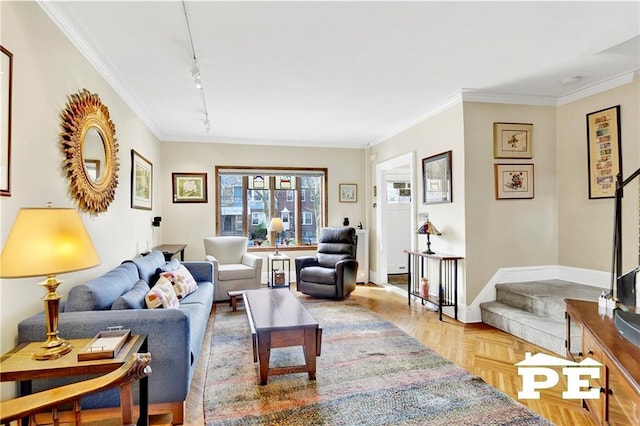 living area featuring stairway, rail lighting, baseboards, and ornamental molding