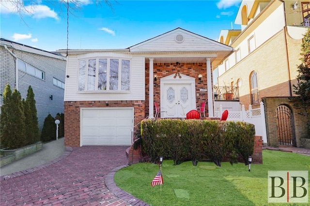 view of front of property featuring decorative driveway, brick siding, an attached garage, and a front yard