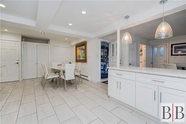 kitchen with pendant lighting, light stone counters, a baseboard heating unit, recessed lighting, and white cabinets