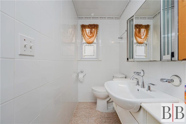 bathroom featuring tile walls, toilet, and tile patterned floors