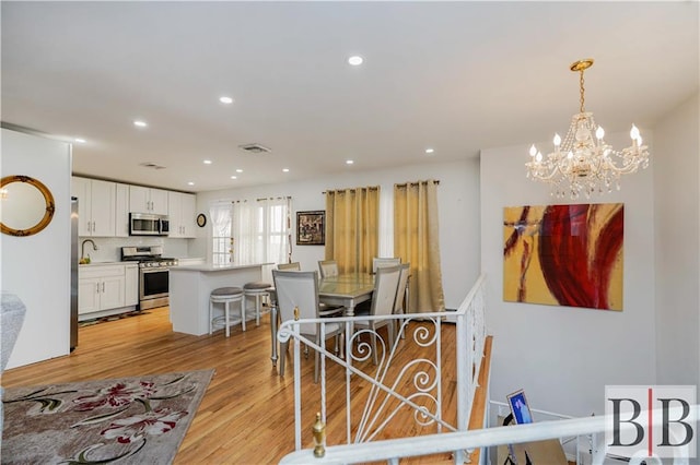 dining room with recessed lighting, visible vents, and light wood finished floors