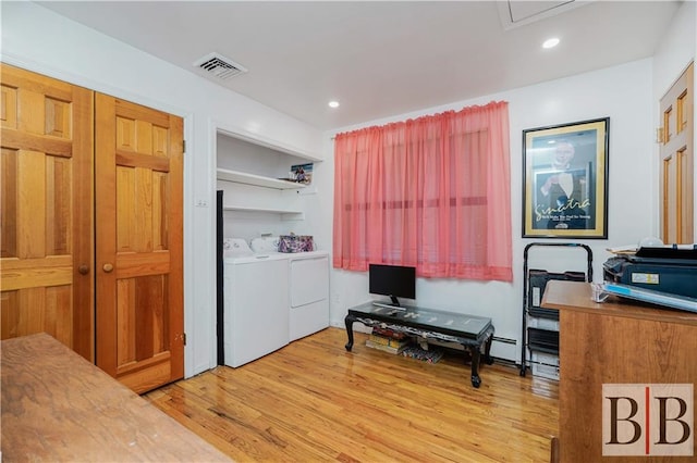 laundry area featuring visible vents, washer and clothes dryer, light wood-style floors, baseboard heating, and laundry area