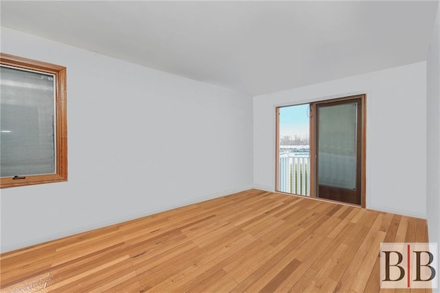 empty room with light wood-type flooring and baseboards