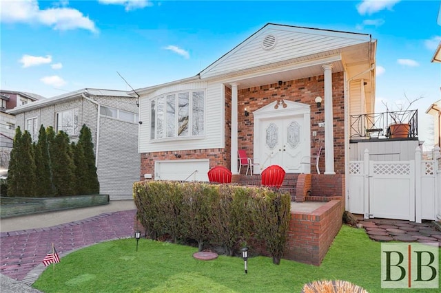 view of front of house with a garage, brick siding, and driveway