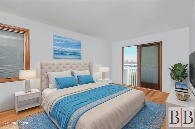 bedroom featuring wood finished floors and access to exterior