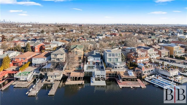 drone / aerial view featuring a residential view and a water view