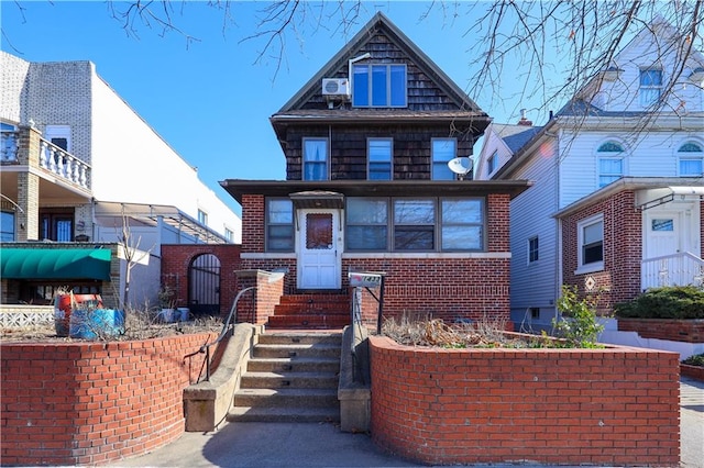 view of front facade featuring entry steps and brick siding