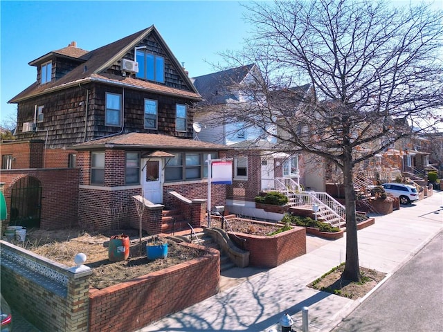 view of front of house featuring brick siding and cooling unit