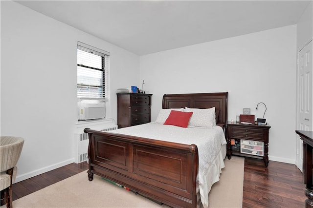 bedroom featuring radiator, baseboards, and dark wood finished floors