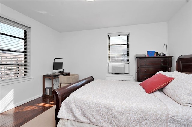 bedroom featuring baseboards and wood finished floors