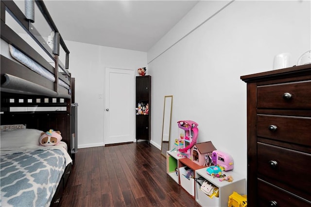 bedroom featuring baseboards and wood finished floors