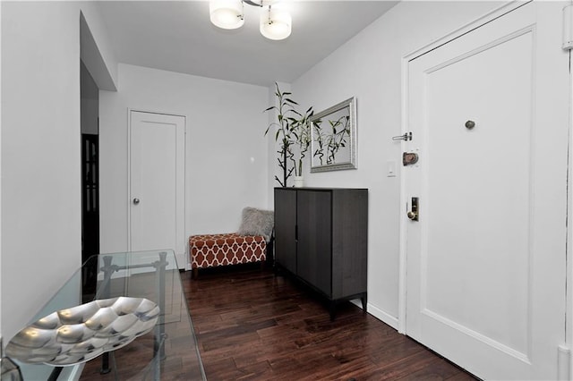 entryway with dark wood-style flooring and baseboards