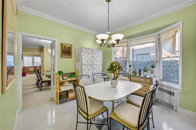 dining space featuring radiator, a chandelier, and ornamental molding