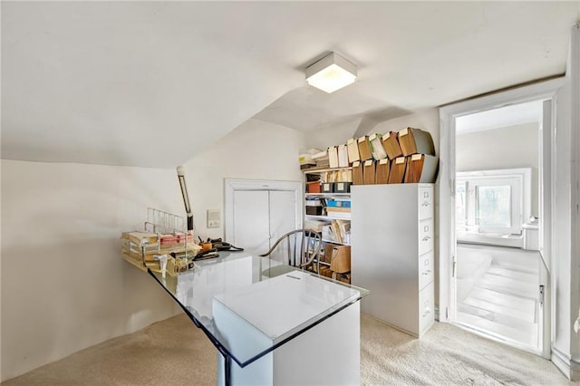 kitchen with light carpet and vaulted ceiling