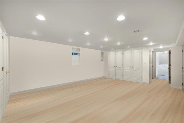 unfurnished room featuring recessed lighting, light wood-type flooring, and baseboards