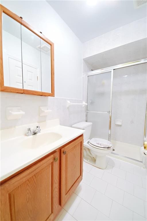 full bathroom with vanity, toilet, and a stall shower