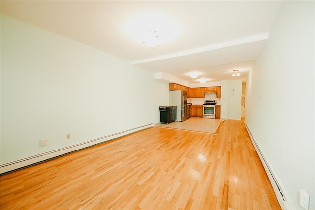 unfurnished living room with light wood-style floors and baseboard heating