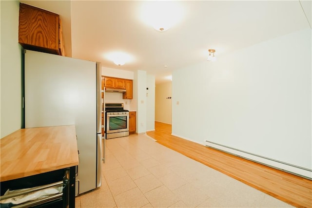 kitchen with a baseboard heating unit, under cabinet range hood, light countertops, brown cabinetry, and stainless steel appliances