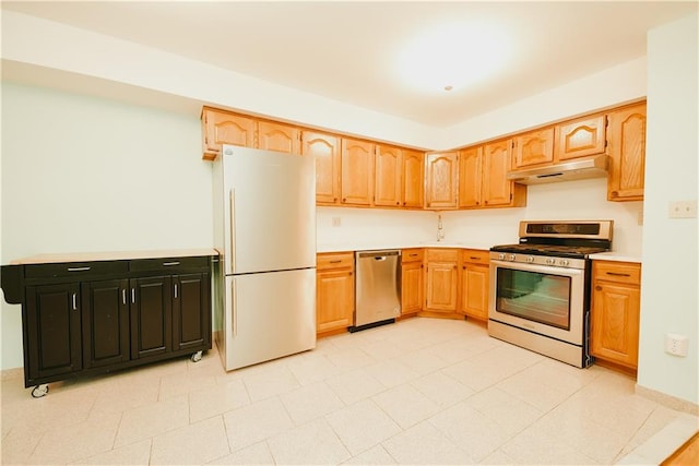 kitchen featuring under cabinet range hood, stainless steel appliances, and light countertops