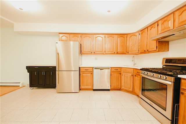 kitchen featuring under cabinet range hood, a baseboard heating unit, a sink, stainless steel appliances, and light countertops