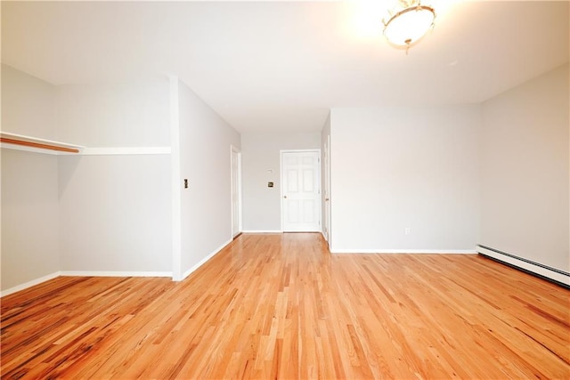 unfurnished room with baseboards and light wood-style floors