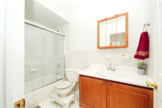 bathroom featuring vanity, toilet, and enclosed tub / shower combo