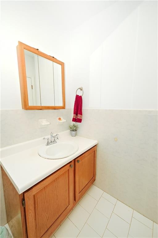 bathroom with vanity, tile patterned floors, and tile walls