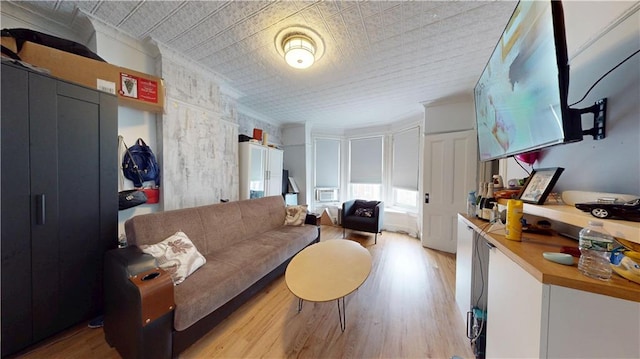 living room featuring an ornate ceiling and light wood-style floors