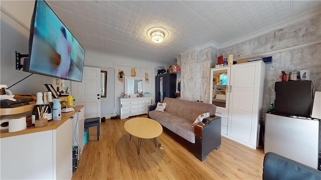 living area with a barn door and light wood-style floors