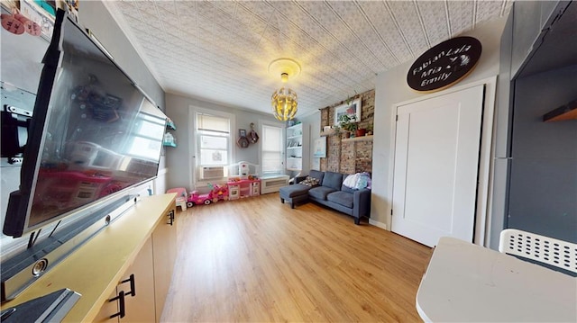 living area with a notable chandelier and wood finished floors