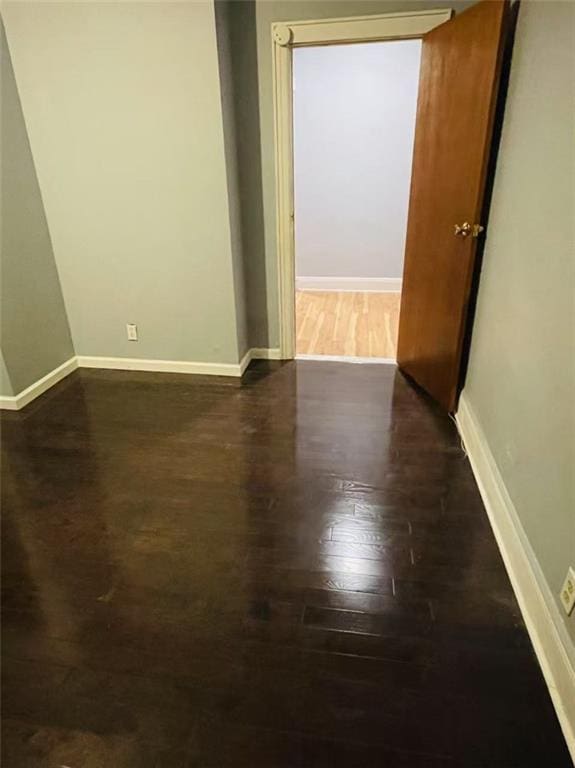 9 Corso Ct, Brooklyn, NY 11223 - empty room with dark wood-style floors and baseboards
