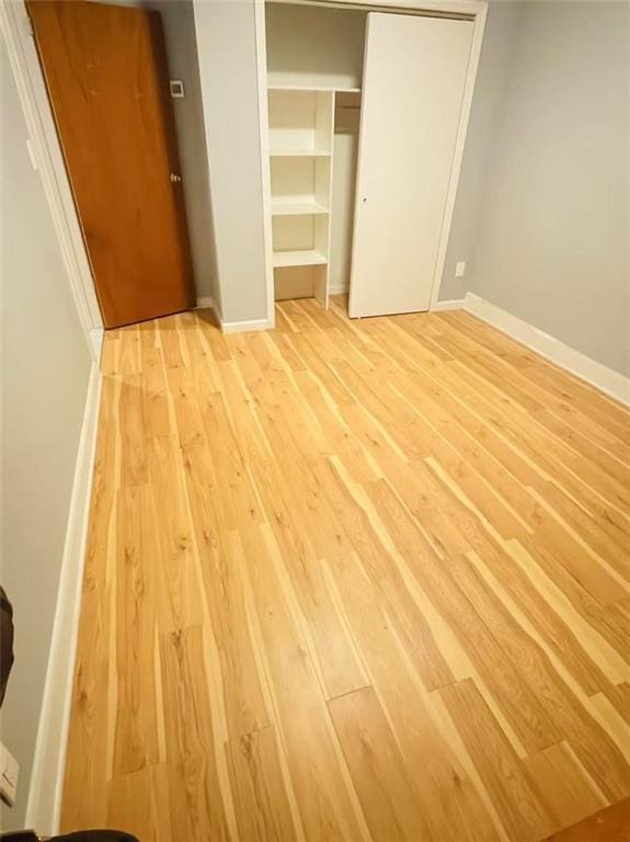 9 Corso Ct, Brooklyn, NY 11223 - unfurnished bedroom with light wood-type flooring, a closet, and baseboards