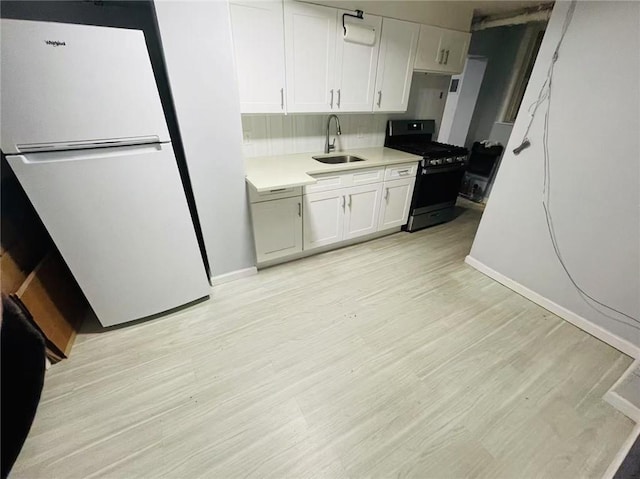 9 Corso Ct, Brooklyn, NY 11223 - kitchen featuring freestanding refrigerator, gas range, a sink, and light wood-style floors