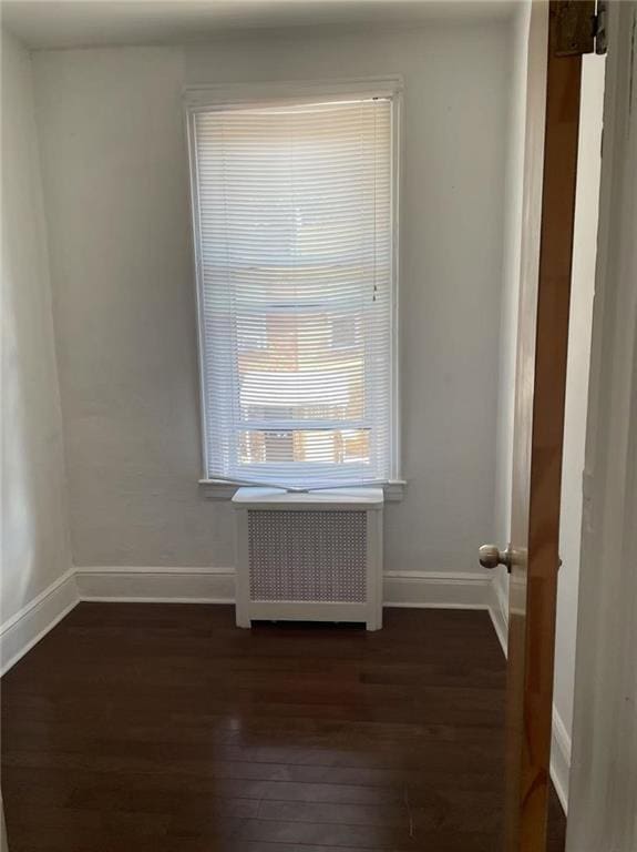 9 Corso Ct, Brooklyn, NY 11223 - unfurnished room with dark wood-style floors, radiator heating unit, and baseboards