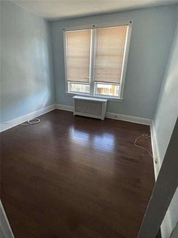 9 Corso Ct, Brooklyn, NY 11223 - unfurnished room with radiator, dark wood-style flooring, and baseboards