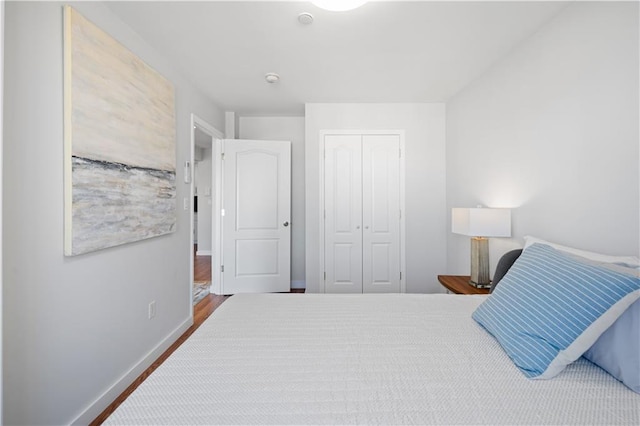 3031 Brighton 5th St Unit 2Fl, Brooklyn, NY 11235 - bedroom featuring a closet, baseboards, and wood finished floors