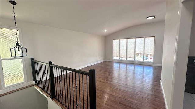 spare room featuring recessed lighting, baseboards, wood finished floors, and vaulted ceiling