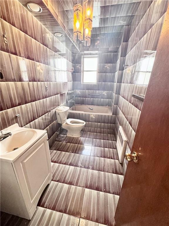 full bath featuring tile patterned flooring, toilet, tile walls, and vanity