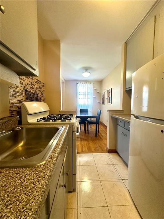 2665 Homecrest Ave Unit 6M, Brooklyn, NY 11235 - kitchen featuring white appliances, backsplash, a sink, and light tile patterned floors