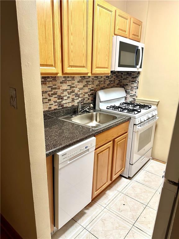 2665 Homecrest Ave Unit 6M, Brooklyn, NY 11235 - kitchen with white appliances, dark countertops, backsplash, and light tile patterned floors