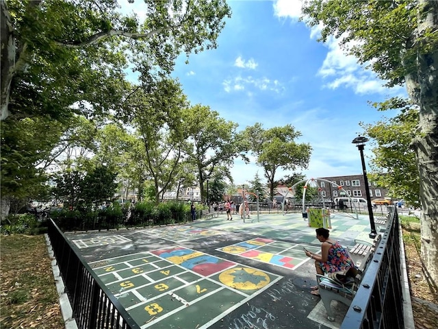 surrounding community featuring shuffleboard and fence