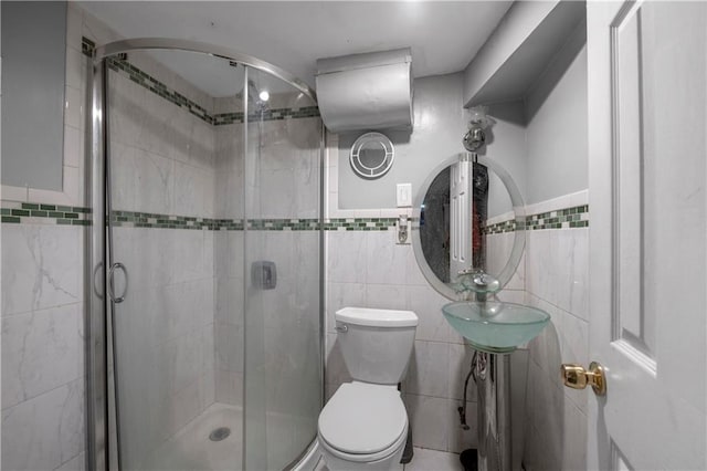 full bathroom featuring toilet, tile walls, and a shower stall