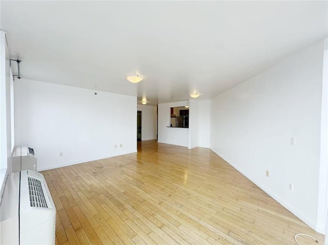 unfurnished living room featuring light wood-type flooring