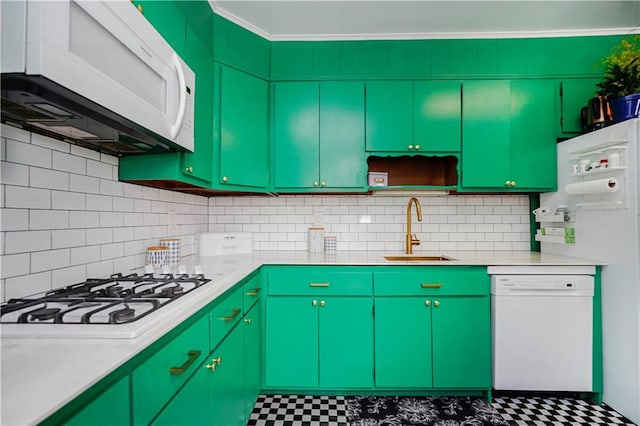 kitchen with white appliances, ornamental molding, a sink, light countertops, and tile patterned floors