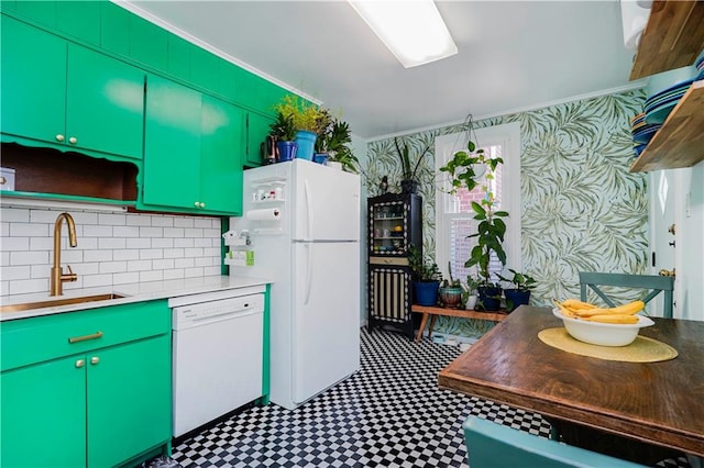 kitchen with decorative backsplash, white appliances, light countertops, and a sink