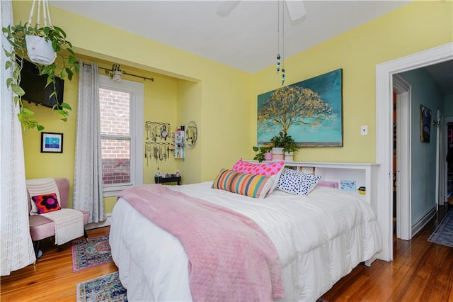 bedroom featuring a ceiling fan and wood finished floors