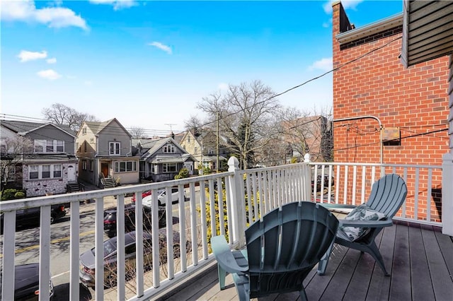 wooden deck featuring a residential view